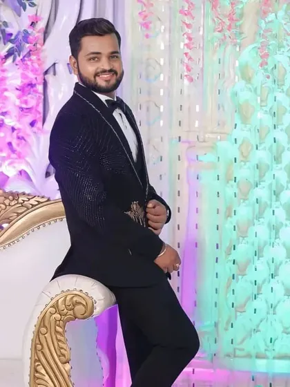 A relaxed pose from the groom. The hair is styled to stay in place, and the makeup is set to last throughout the evening's festivities.