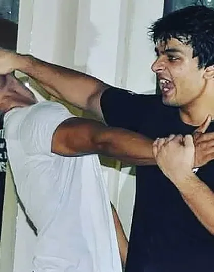 In a real fight for your life, you must be willing to do what is necessary. This shows an eye strike, a technique targeting a vulnerable point to create an opportunity to escape.