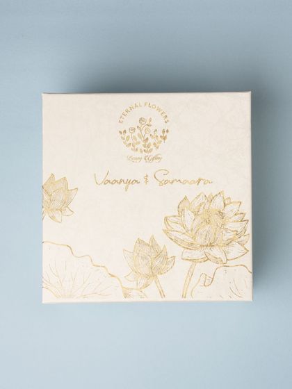A close-up of the beautifully designed custom box lid for the twins' naming ceremony, featuring their names in gold foil.