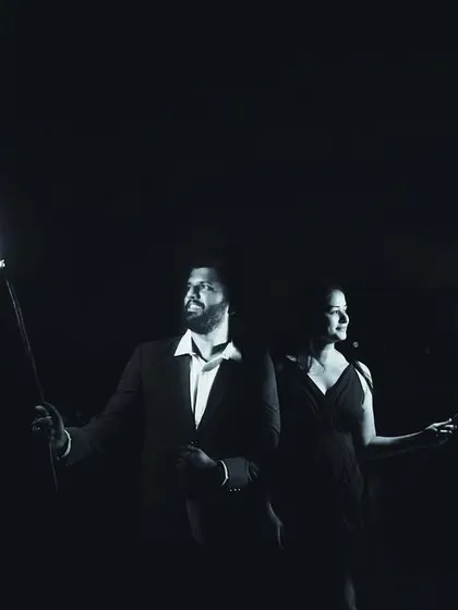 A creative black and white shot using fire torches for a dramatic effect. This pre-wedding photo has a powerful, almost primal feel, symbolizing the flame of love.