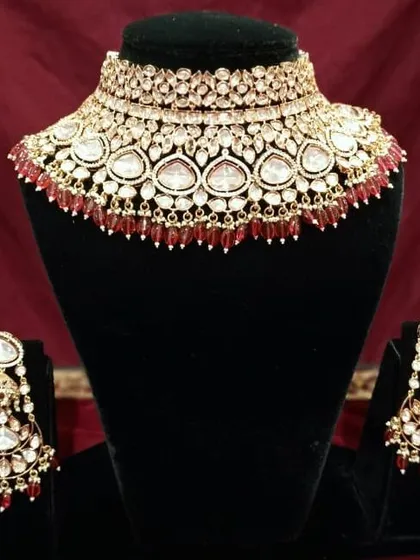 This Kundan choker set is detailed with rich red beads, making it a perfect match for a traditional red bridal lehenga.