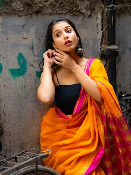 A candid moment of adjusting an earring. These little actions bring a sense of realism and personality to a photoshoot.
