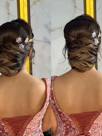 A detailed look at a reception bun with soft, interwoven sections and sparkling star-shaped accessories, created for a makeup seminar in Nasik.