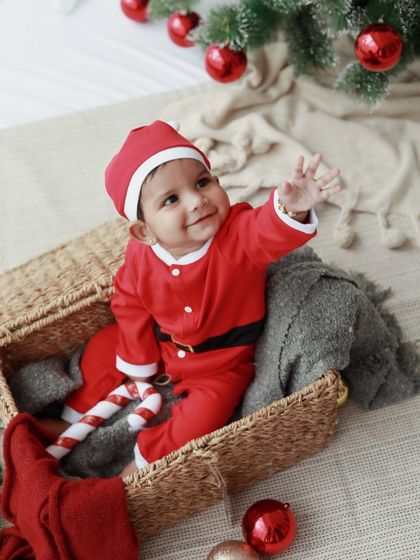 Waving bye bye to the year! This little Santa is ready to welcome the new year with a smile.