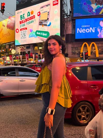 Posing in front of the bright billboards of Bukit Bintang. This shot is all about capturing the excitement of a bustling city nightlife.