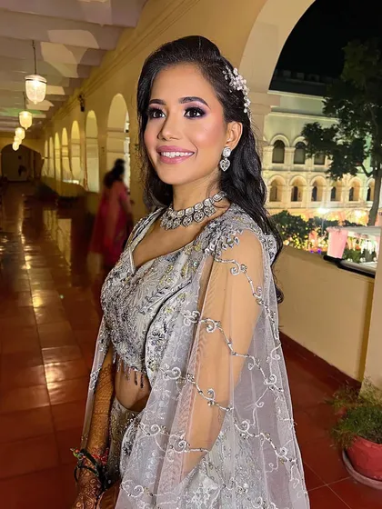 A happy, smiling shot of this client at her engagement party. The hair accessory adds a touch of sparkle to her elegant and glamorous look.