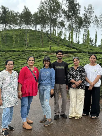 A group of friends posing in a tea plantation in Wayanad.