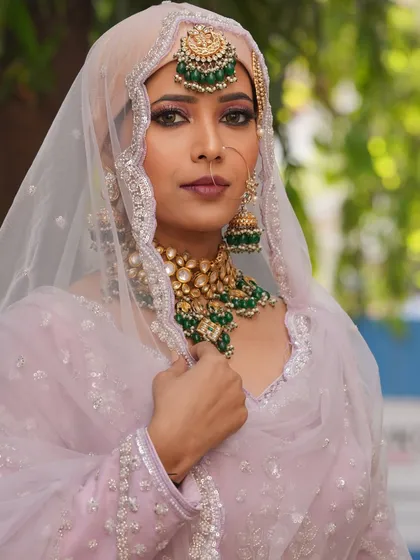 This angle shows the delicate detailing on the headscarf and the way the makeup complements it.