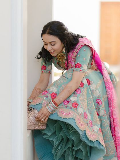 A candid moment of the bride adjusting her shoe. These little, unposed moments add a touch of reality and charm to the wedding album.