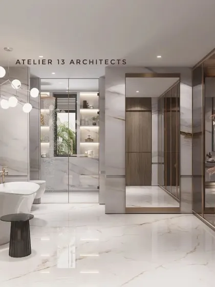 This master bathroom combines opulence and function with floor-to-ceiling white marble and a freestanding bathtub set against a dramatic piece of art. The adjoining walk-in closet features glass and bronze-trim doors, offering a seamless transition from personal care to bespoke storage.