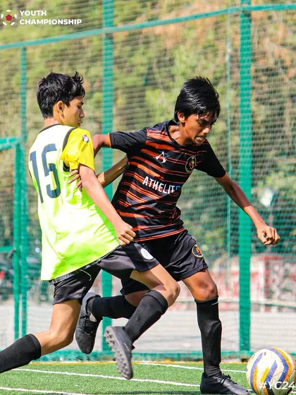 Speed, skill, and sheer determination. A player dribbles past an opponent in a display of talent.