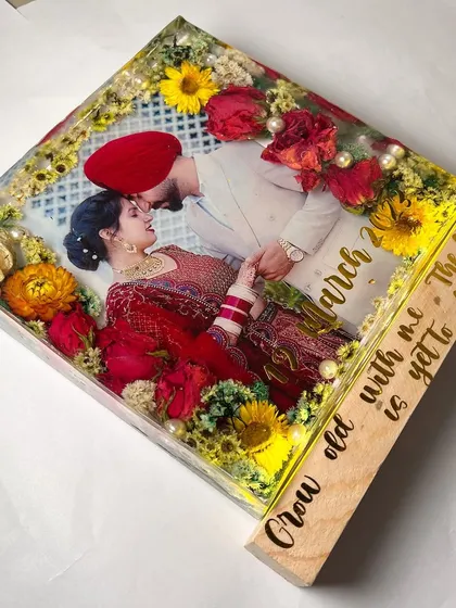 An angled view of the square block art, showing the thickness of the resin and the beautiful arrangement of the flowers. The LED light base makes it glow.