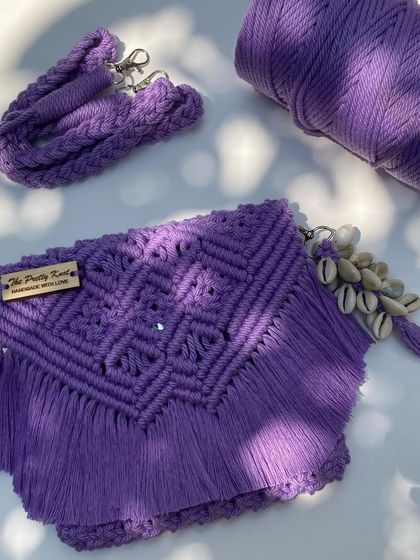 Our lavender fringe bag paired with a matching shell keychain. This set is perfect for anyone who loves a coordinated look. The bag measures 8 by 7 inches.