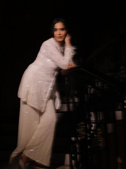 This motion-blur photo captures a sense of movement and ethereal grace. It's an example of a more creative and artistic style of modeling, suitable for editorial or campaign work that aims for a unique visual impact.