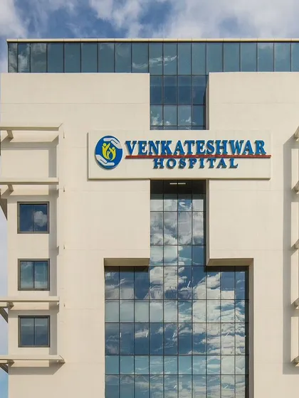 A close-up of the Venkateshwar Hospital facade, reflecting the sky in its large glass panels. This IGBC Gold-rated project demonstrates our commitment to sustainable and modern healthcare design.