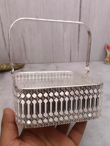 A square German silver basket with a handle, a modern and stylish option for your pooja needs.