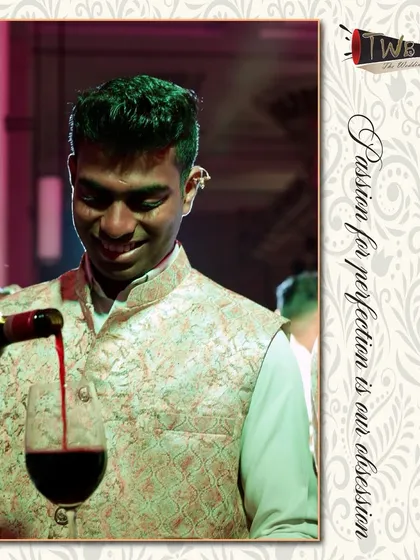 A bartender pours a glass of red wine, part of our complete beverage catering service that includes wine and spirits.