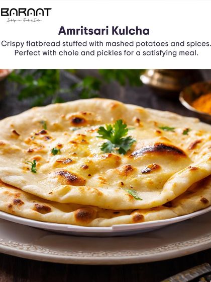 The classic Amritsari Kulcha is a crispy flatbread stuffed with mashed potatoes and spices, perfect with chole and pickles.