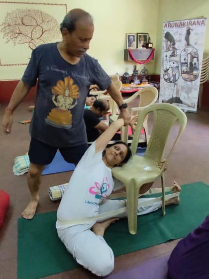 Assisting a student with a chair.