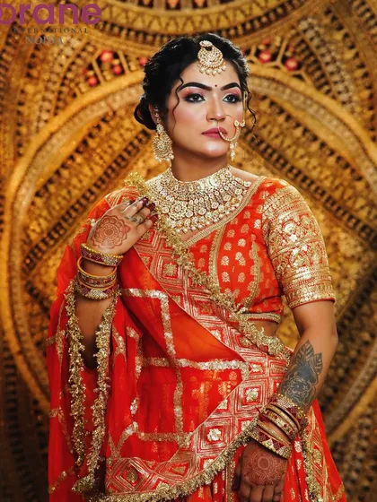 A classic bridal look in red and gold, showcasing timeless makeup techniques that are always in demand.