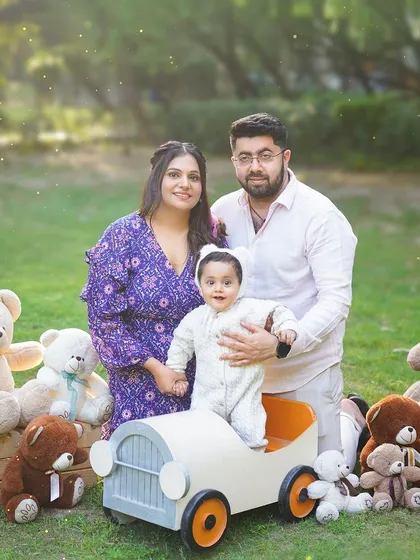 A fun, themed outdoor family shoot with a vintage toy car and a crowd of teddy bears. This creates a playful and unique setting for a first birthday.
