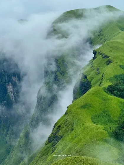 Witness the raw beauty of the Western Ghats from Netravathi Peak. This is the kind of breathtaking view we live for, with clouds swirling around the sharp, green ridges. It’s a perfect shot of the wild, untouched nature we explore.