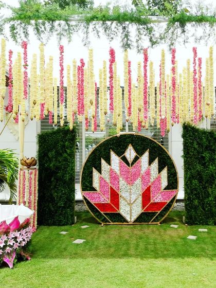 A modern naming ceremony decoration featuring a geometric lotus motif made from flower petals.