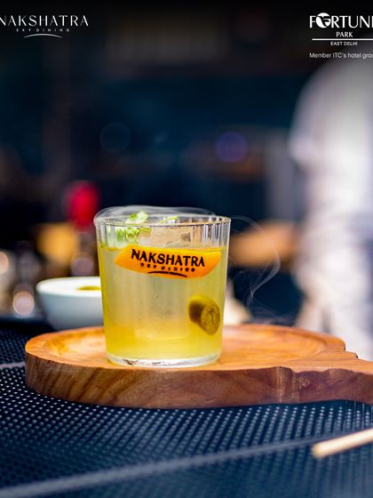 The Nakshatra signature cocktail, steaming with aromatic smoke, ready to be served.
