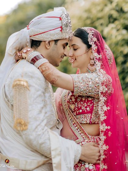 A close-up, intimate embrace between the bride and groom, capturing the raw emotion and connection in the moments after their wedding ceremony.