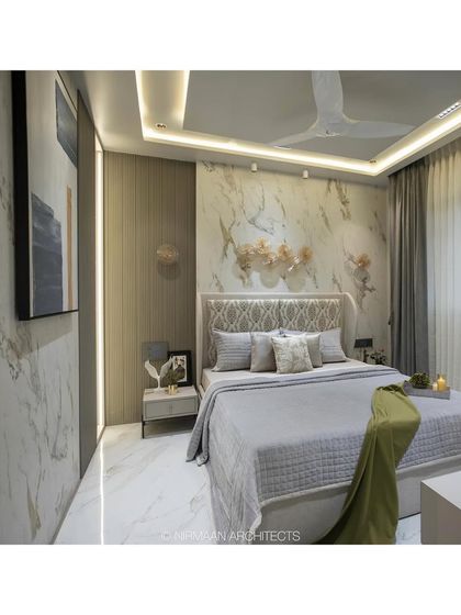 The master bedroom in the Duplex Project is a lesson in luxury. A marble-clad wall, gold-finished art pieces, and plush fabrics come together to create a truly opulent and restful space.
