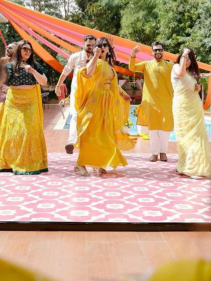 A fun, choreographed dance moment from a poolside Haldi. We used colorful drapes and a patterned dance floor to create a festive space for guests to celebrate and make memories.