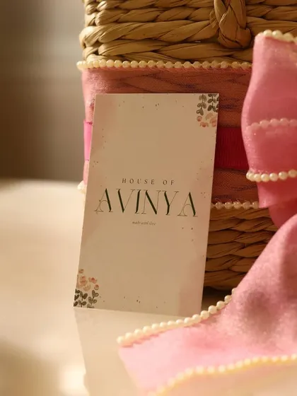 A close-up shot of our branding, featuring the elegant House of Avinya card against a beautifully wrapped gift. Every detail is a part of the story we help you tell.