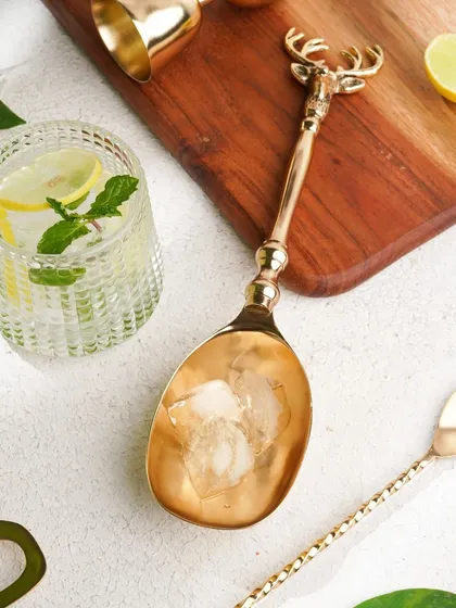 Another angle of the deer-themed ice scoop, this time in action with ice, demonstrating its use in a stylish way.