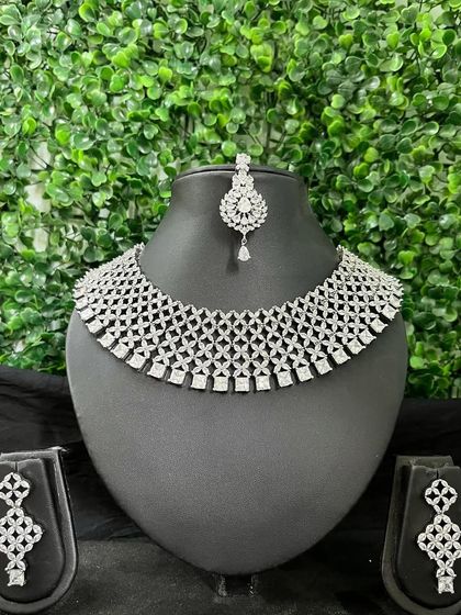 A full American Diamond choker set with a delicate web-like pattern, complete with matching earrings and maang tikka.