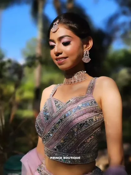 A close-up portrait highlighting the stunning bead and sequin work on the blouse, paired with delicate rose gold jewellery.