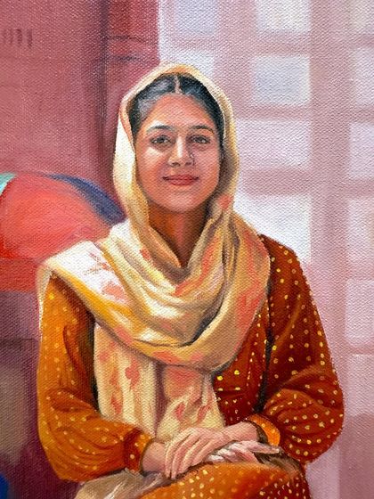 A close-up of the young woman's face from the Punjabi portrait, capturing her gentle smile.