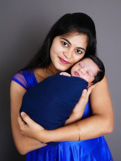 A mother's love captured in a single frame, as she holds her sleeping newborn close. A simple, powerful portrait.