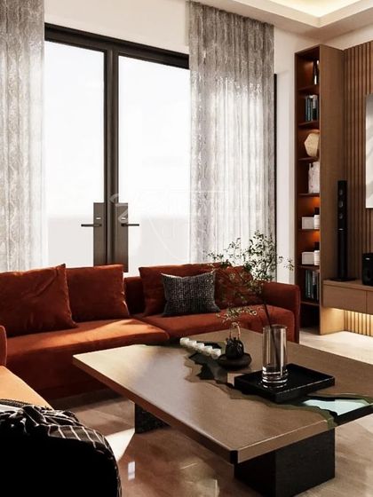 Here you can see how the warm, rust-colored sofa brings a pop of color and comfort to the living space. We chose sheer curtains to allow natural light to fill the room, creating a bright and airy atmosphere perfect for a family getaway.