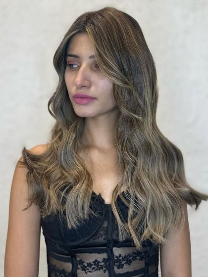 A side profile of the stunning golden balayage. The color is warm and sun-kissed, perfectly complementing her skin tone.