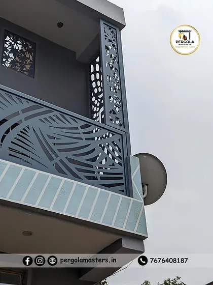 A custom-designed balcony featuring a laser-cut railing and privacy screen with a flowing, nature-inspired pattern. This artistic metalwork enhances the building's exterior, turning a functional element into a piece of art.
