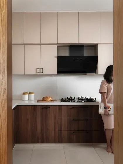 This kitchen is a study in quiet contrasts. I paired the warmth of walnut lower cabinets with muted taupe upper units, grounded by matte black accents. The result is a space that feels as serene as it is functional, with clean lines and concealed hardware for a seamless finish.