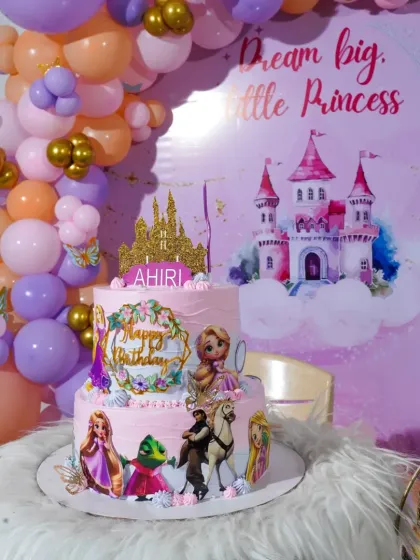 The Rapunzel cake as the star of a "Dream Big, Little Princess" party setup. It looks beautiful surrounded by matching balloons and decor.