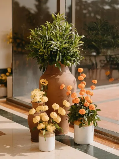 We used a mix of terracotta and ceramic pots with different types of marigolds and greenery for a rustic and organic feel.