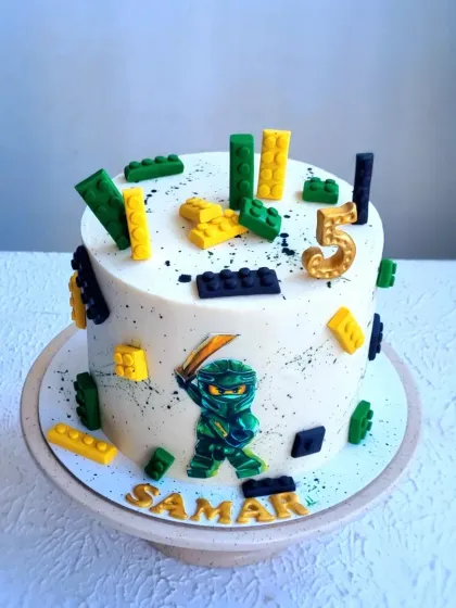 Another angle of the Ninjago cake, showing the splatter effect and fondant details.