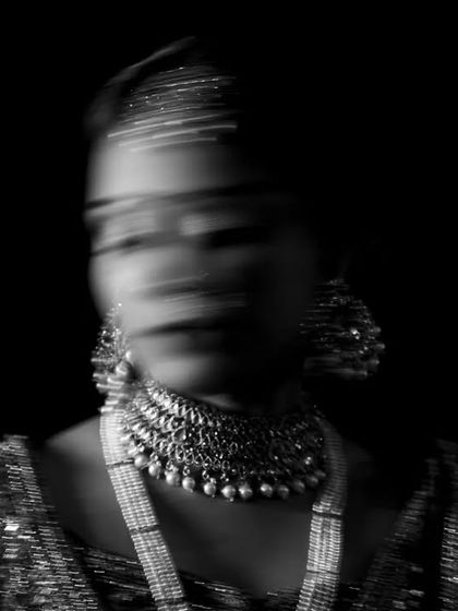 A creative black and white portrait using motion blur. This technique adds a dynamic and ethereal quality to the bride's image.