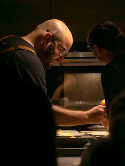 Me in the kitchen during a pop-up event, focused on getting the details right.