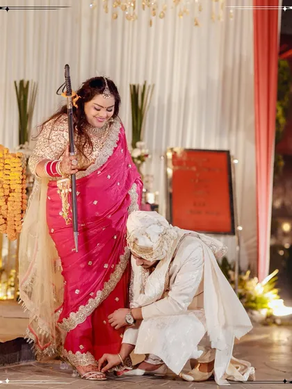 A playful and traditional moment from the wedding ceremony, capturing a fun ritual between the bride and groom.