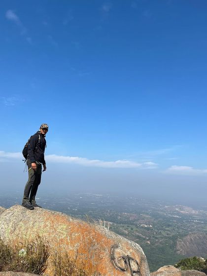 Standing on one of the giant monolithic rocks that make Savandurga a unique trekking challenge.