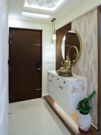 Another view of the Pashmina Waterfront foyer, highlighting the fluted wooden panel, golden mirror, and layered lighting that create a balanced and graceful look.