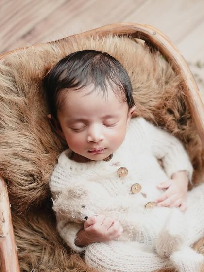 Our sweetest little boy. A simple knit outfit and a rustic basket lined with fur create a cozy and timeless portrait.